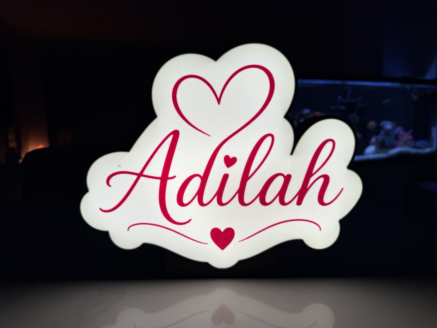 White Adilah name lightbox with pink lettering and hearts