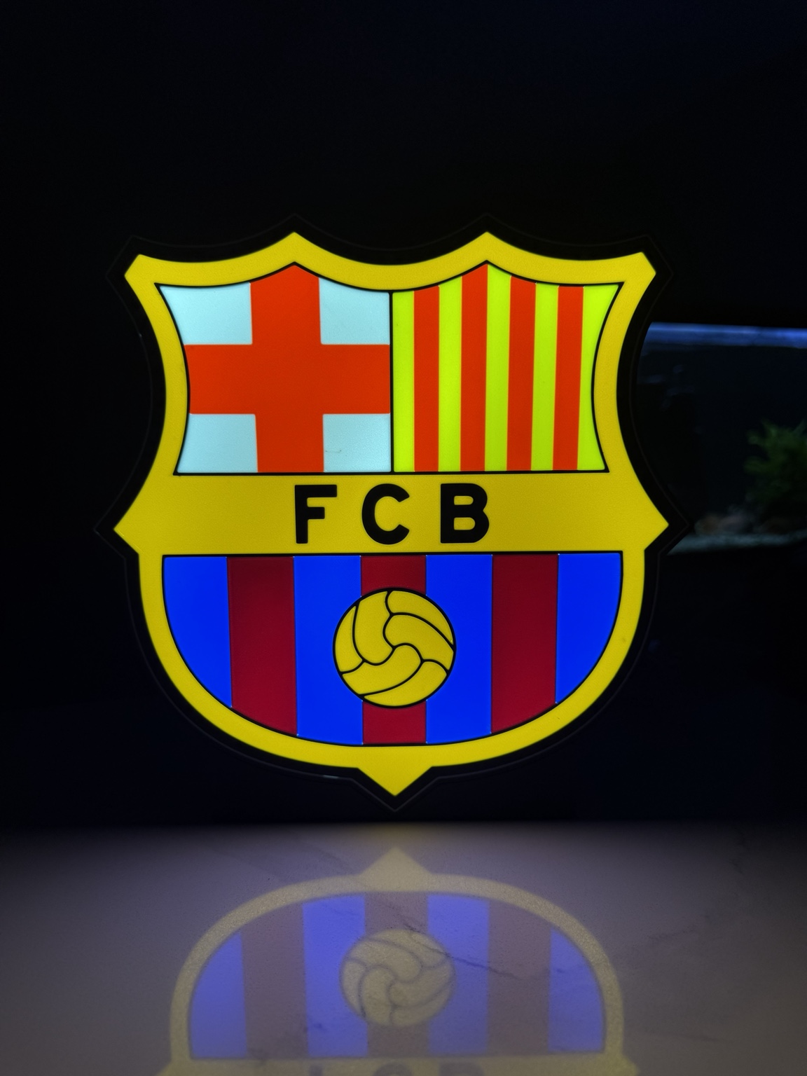 FC Barcelona crest illuminated in red blue and yellow