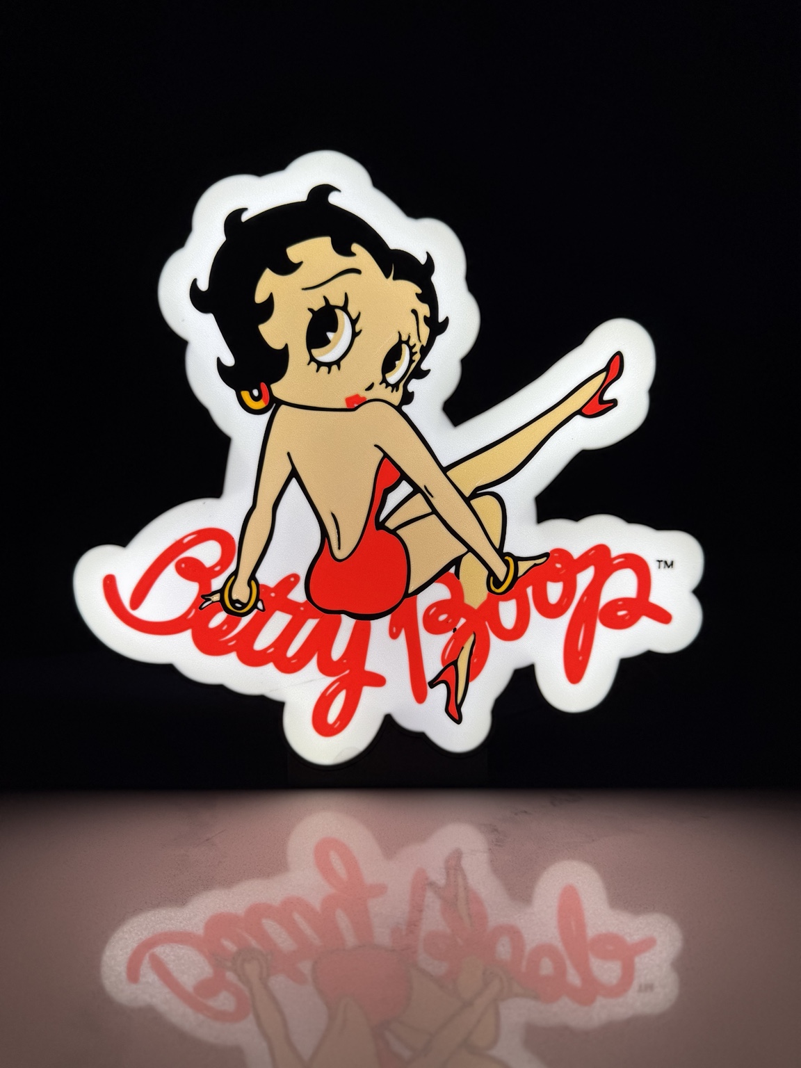 Betty Boop character and red lettering illuminated as a lightbox