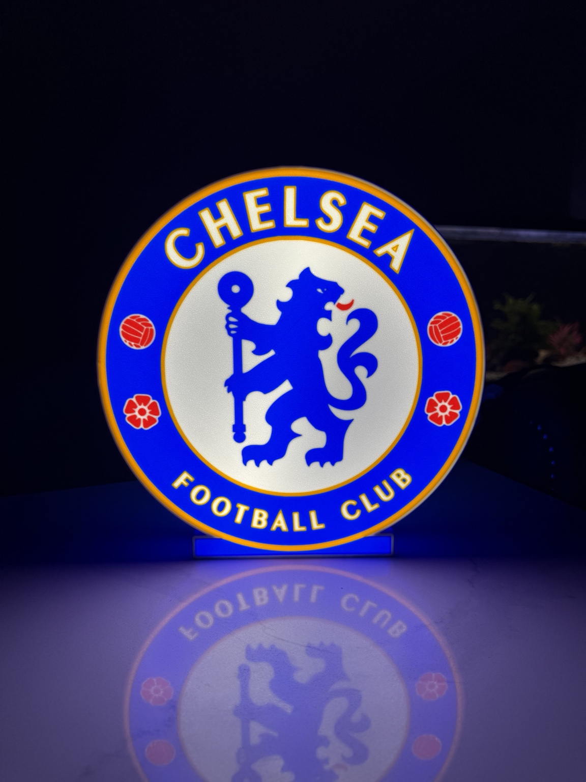 Blue and white Chelsea Football Club circular illuminated sign