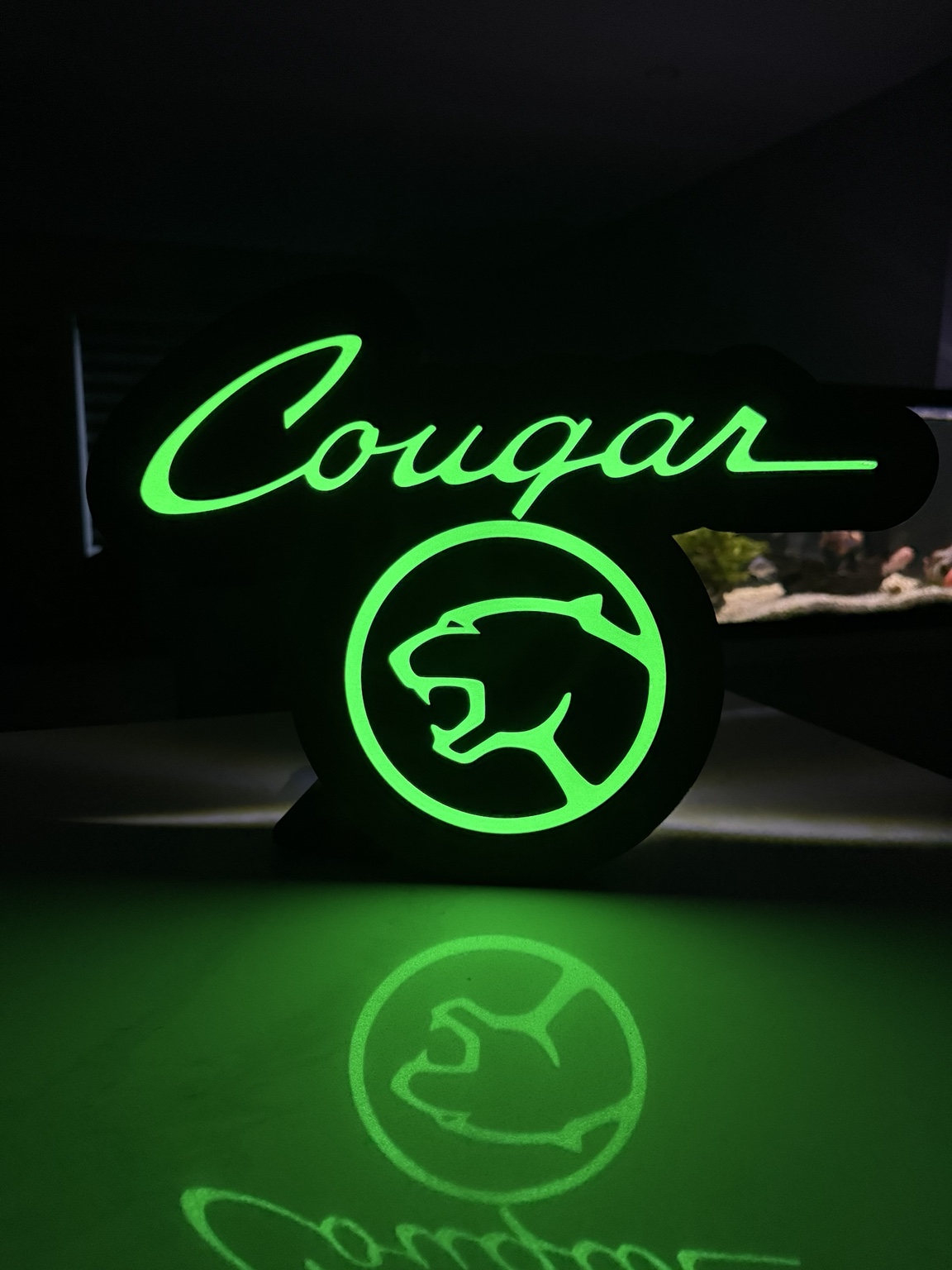 Green illuminated Cougar lettering and cat emblem