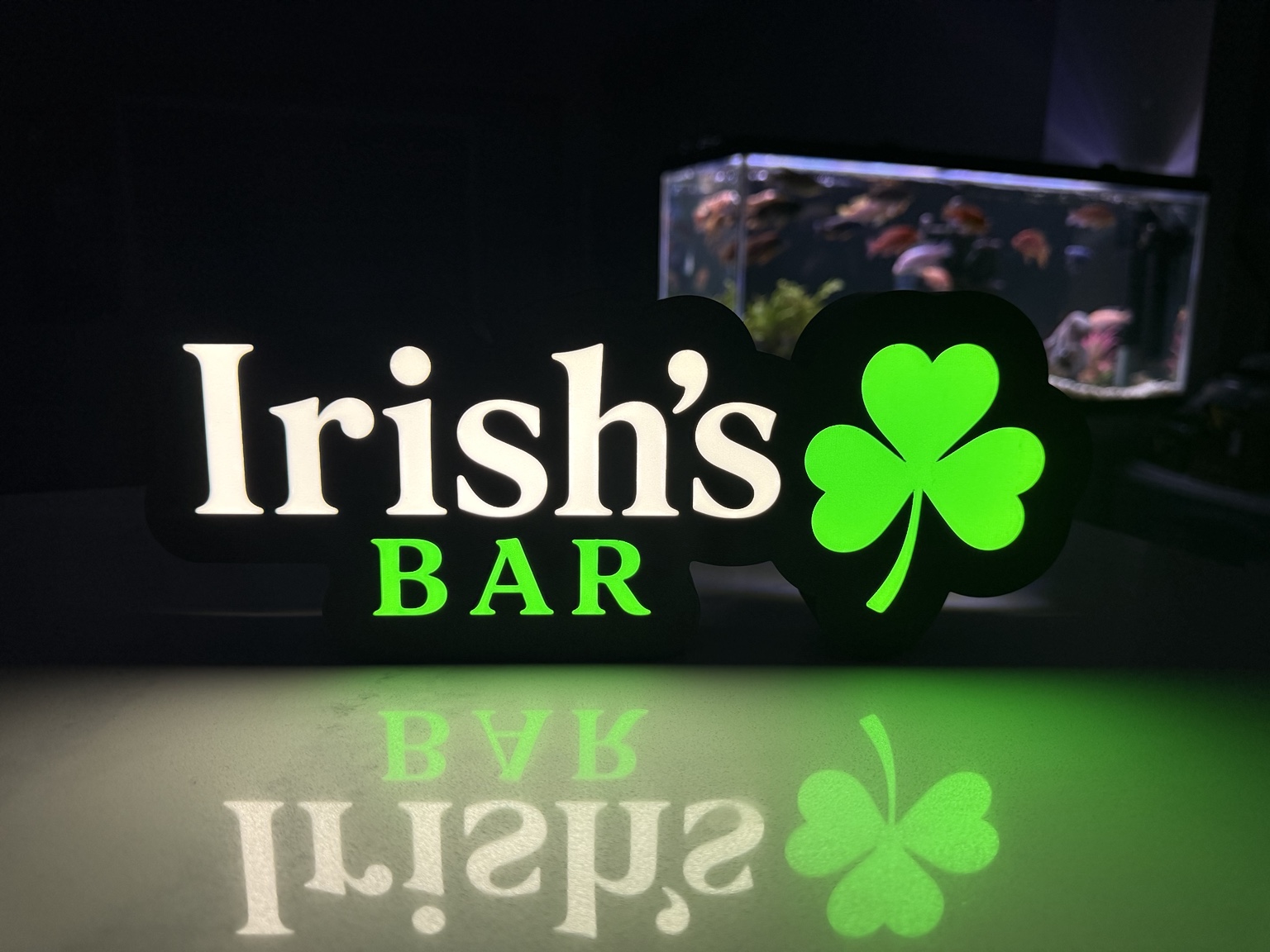 Irish's Bar lightbox with white lettering and a green shamrock