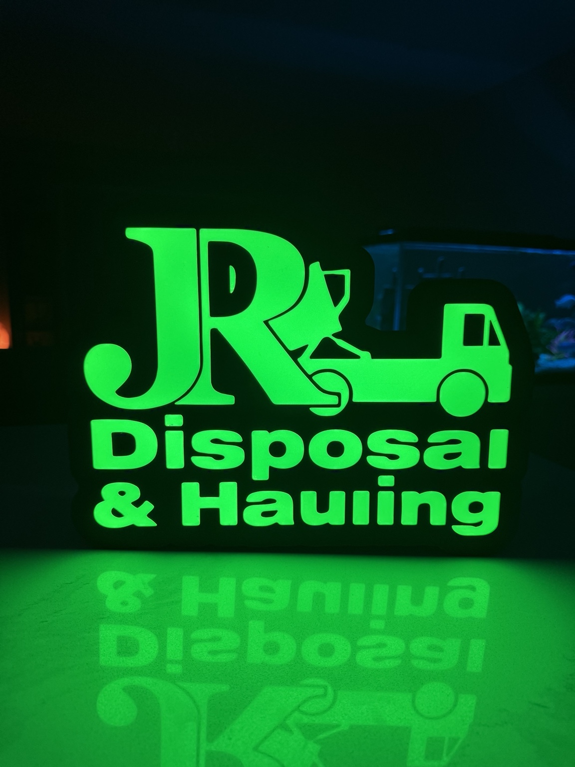Green JR Disposal and Hauling illuminated lightbox with truck silhouette