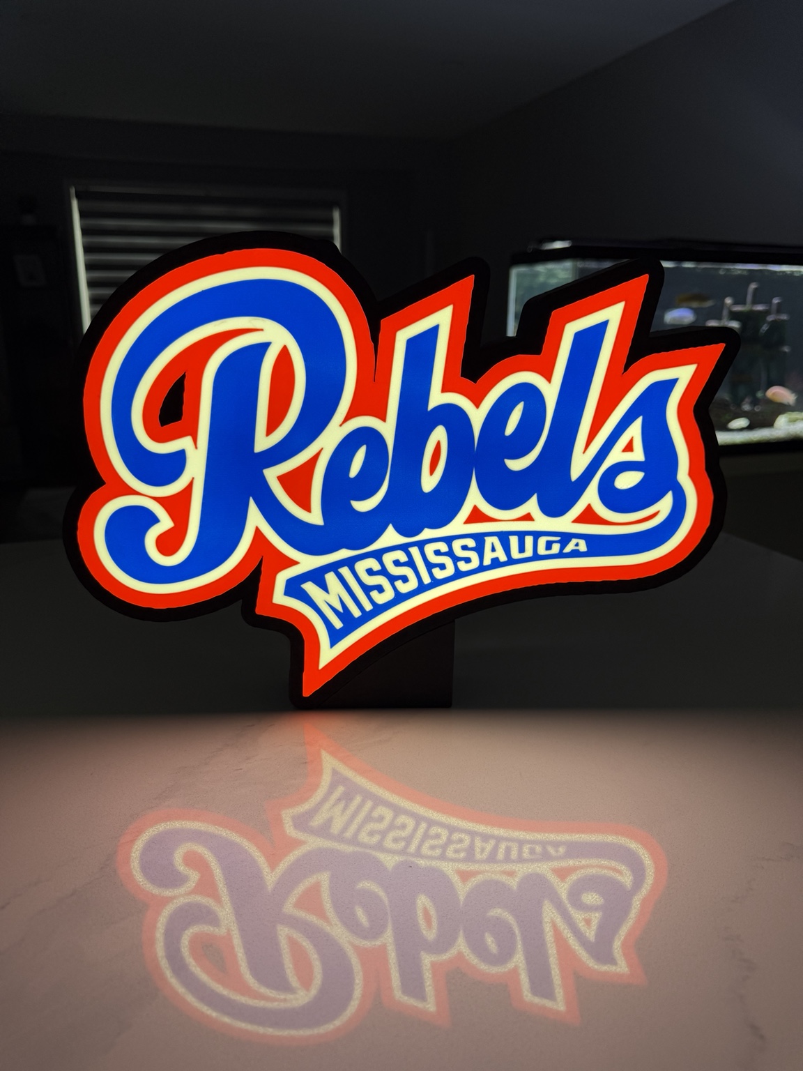 Red white and blue Mississauga Rebels illuminated sign