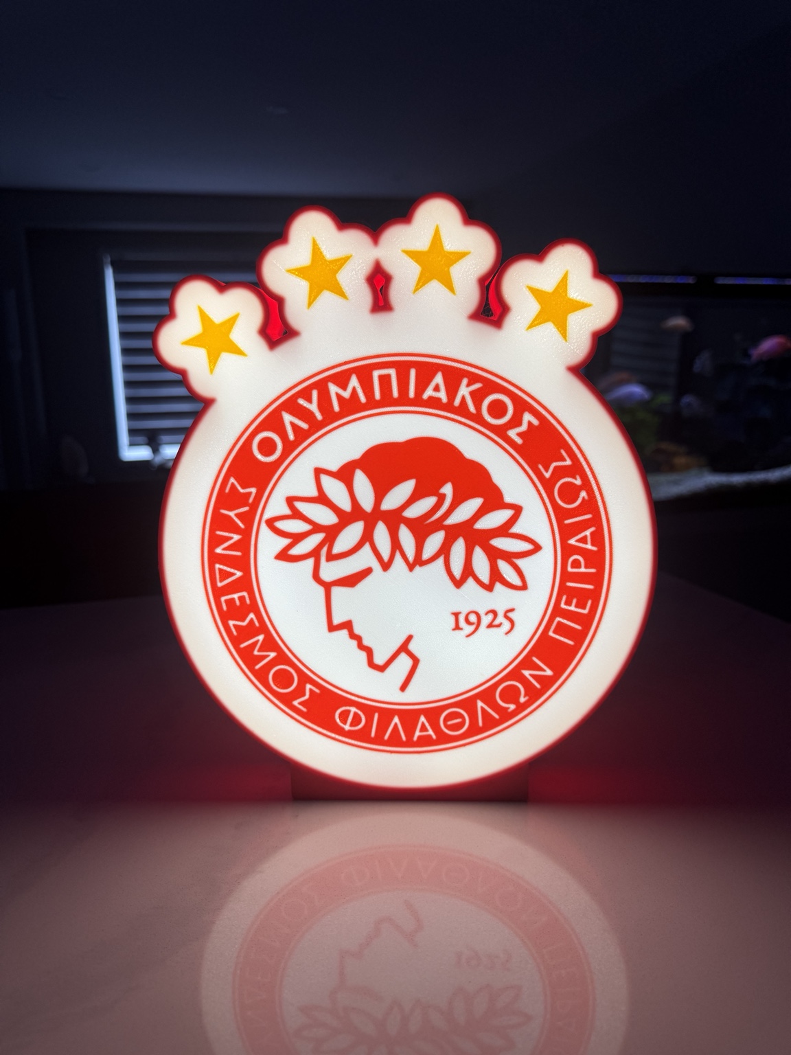 Red and white Olympiacos themed circular lightbox with stars