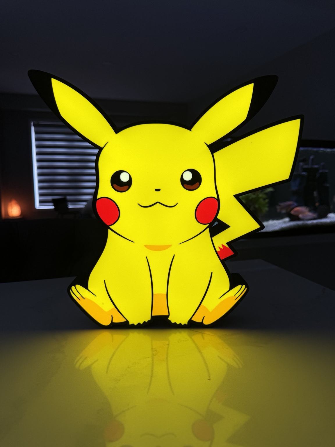 Pikachu character illuminated in yellow and red