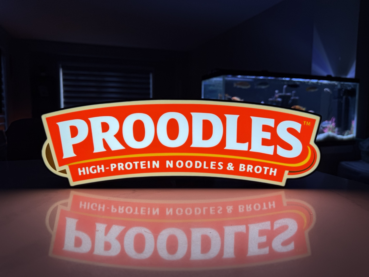 Red and white Prooodles high-protein noodles illuminated sign