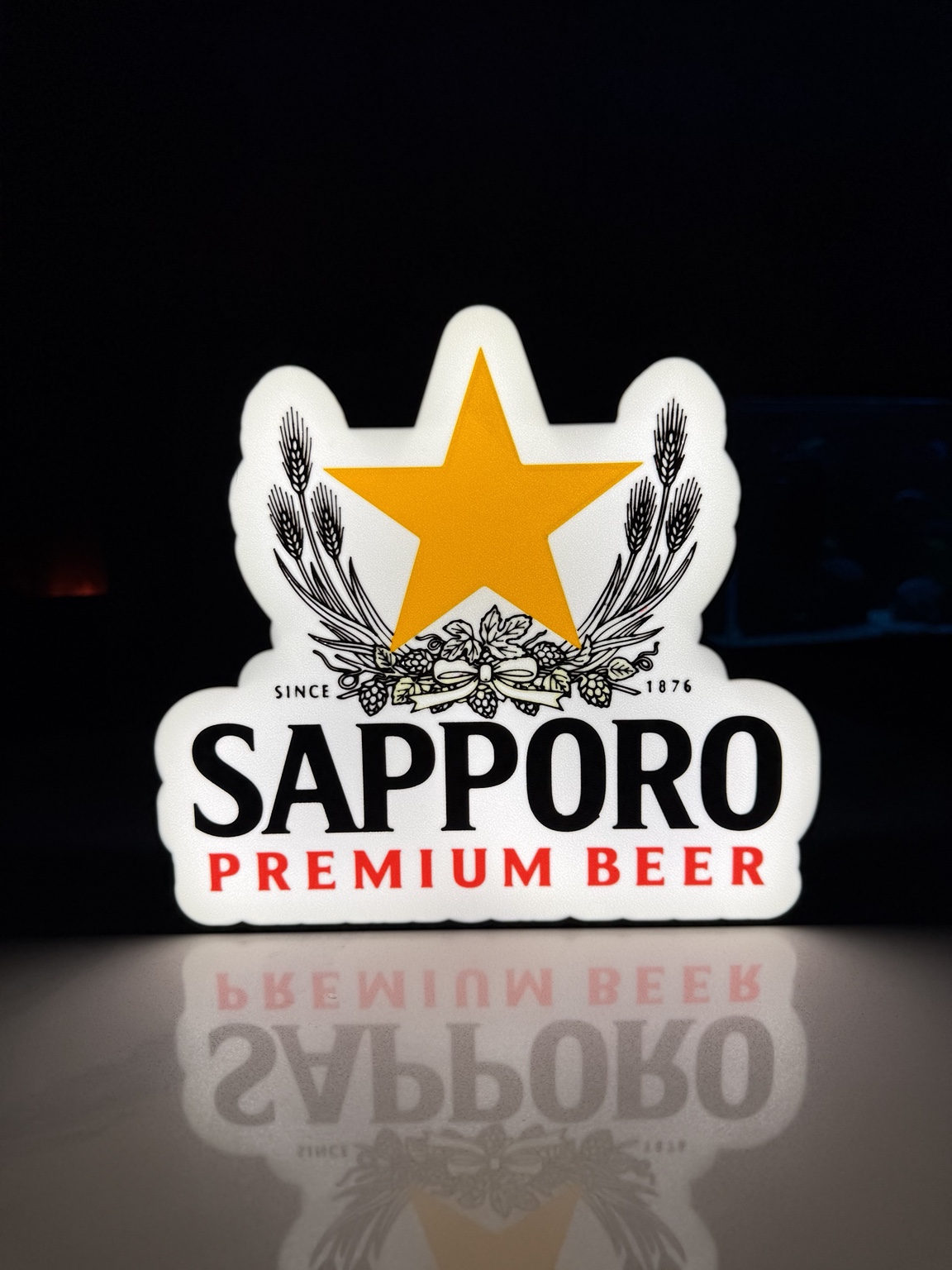 Sapporo Premium Beer lightbox with gold star and white face
