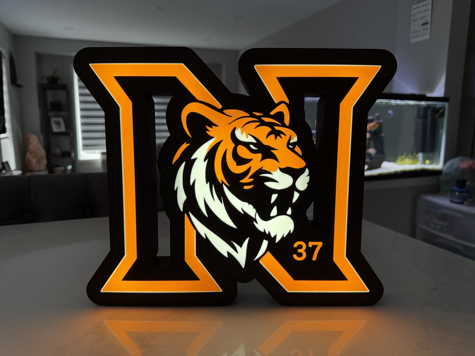 Orange H shaped illuminated lightbox with tiger face and number 37