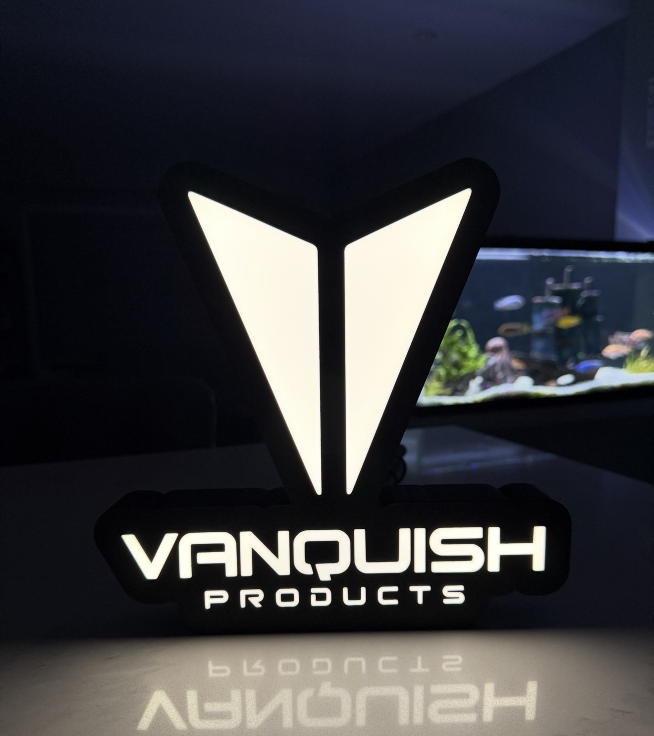 White Vanquish Products illuminated sign